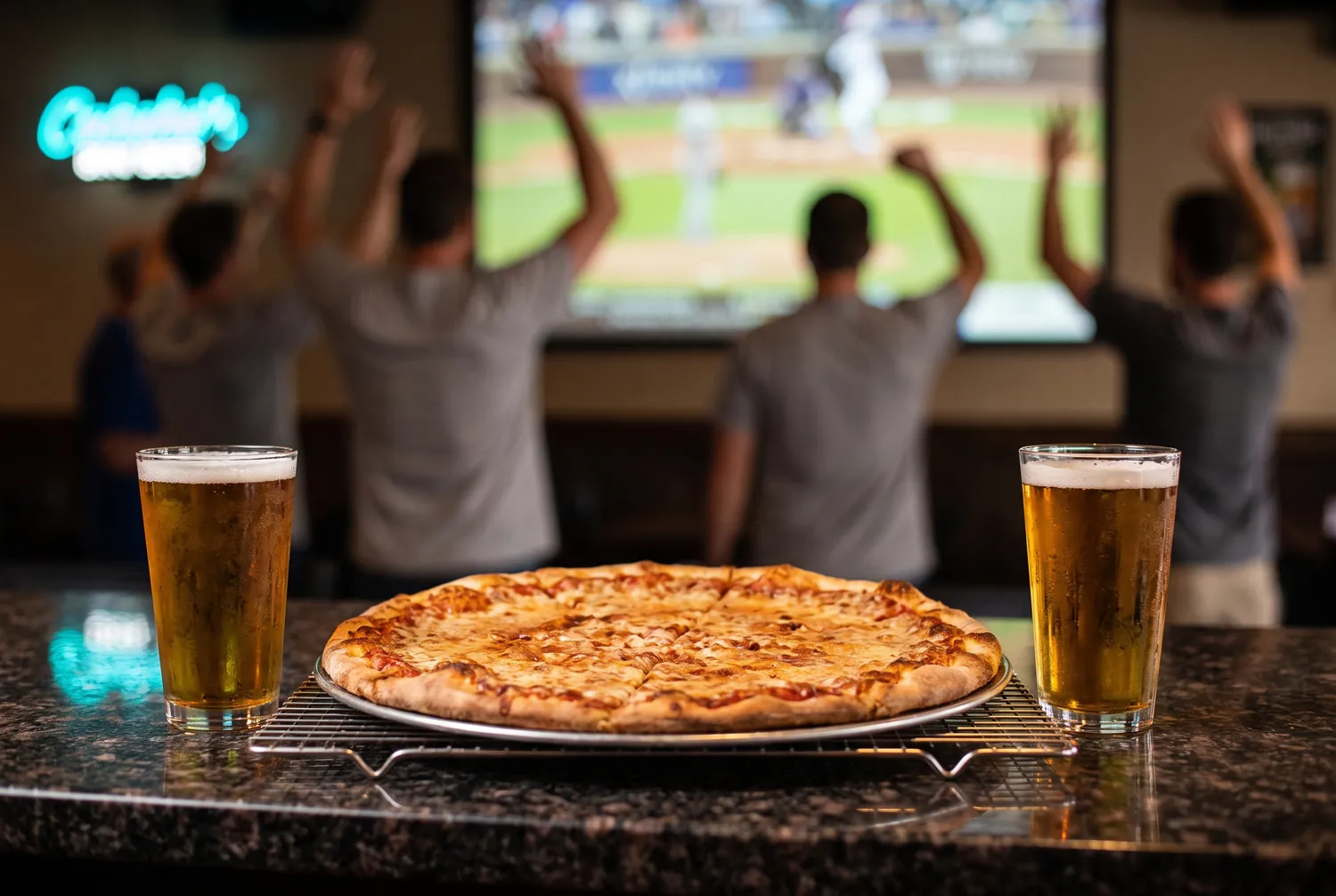 Pizza and beer at the bar while fans cheer a baseball game near Petco Park Pizza and beer at the bar while fans cheer a baseball game near Petco Park